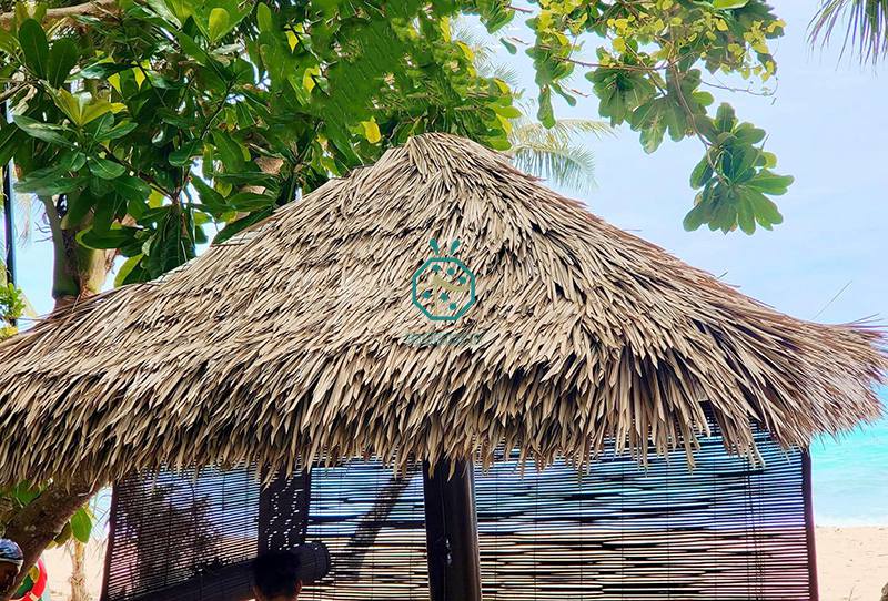 Beachfront tiki bars for tourist with artificial nylon thatch roof covering